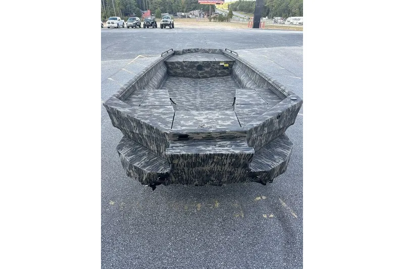 Slide: The Image of 2025 Havoc 1860 boat with camouflage design, parked on asphalt. - 10