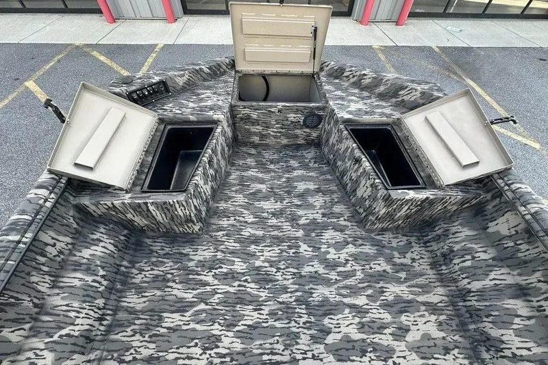 Slide: The Image of 2025 Havoc 1860 boat interior with camo design and open storage compartments. - 4
