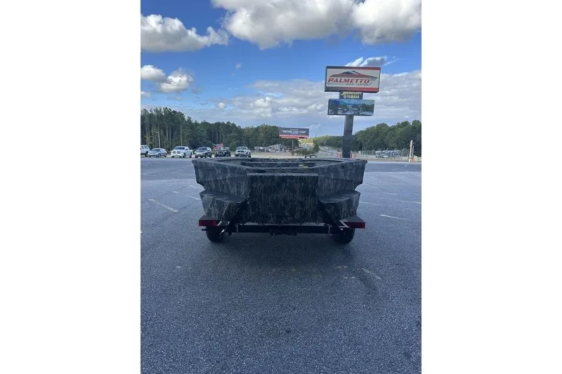 Slide: The Image of 2025 Havoc 1860 boat on trailer, parked in lot under cloudy sky. - 5