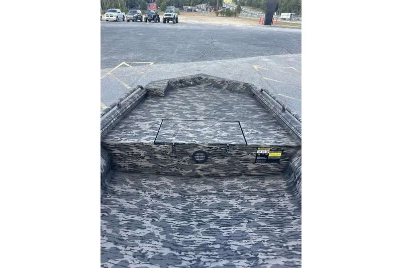 Slide: The Image of 2025 Havoc 1860 boat with camouflage interior, parked in a lot. - 6