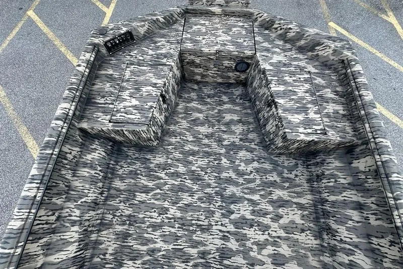Slide: The Image of 2025 Havoc 1860 boat interior with camouflage pattern, featuring storage compartments. - 9