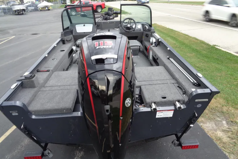 Slide: The Image of 2026 Lund 1775 Adventure Sport boat with Mercury 115 Pro motor, parked on pavement. - 12