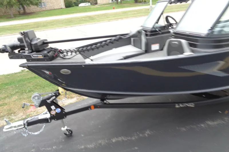 Slide: The Image of 2026 Lund 1775 Adventure Sport boat on trailer, parked on driveway. - 3