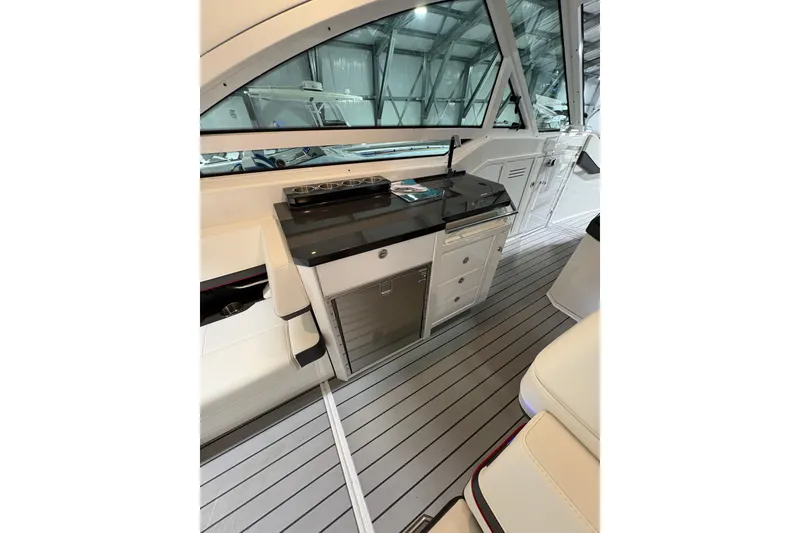 Slide: The Image of 2023 Formula 400 Super Sport Crossover interior with sleek kitchenette and modern design. - 24