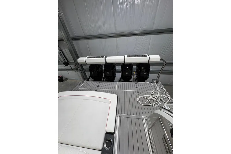Slide: The Image of 2023 Formula 400 Super Sport Crossover boat with triple outboard engines in a garage. - 25