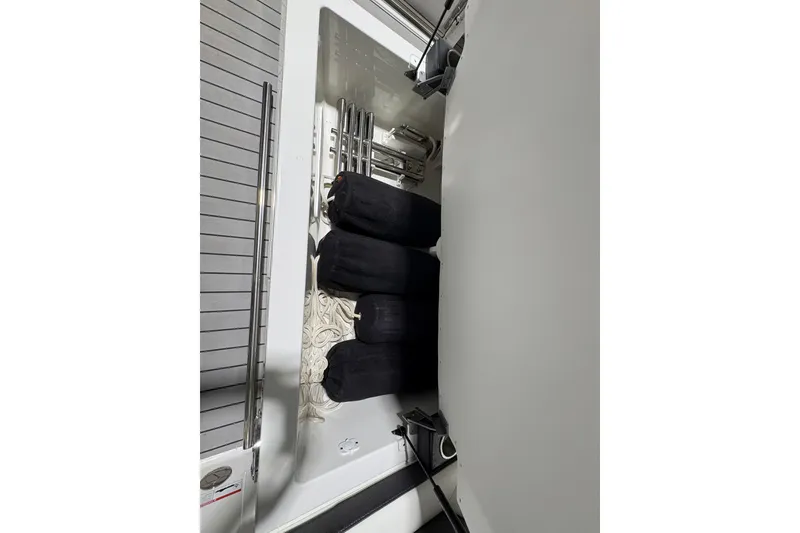 Slide: The Image of Storage compartment in 2023 Formula 400 Super Sport Crossover boat, featuring neatly organized equipment. - 28