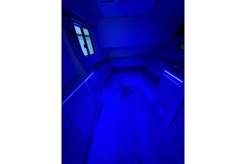 Slide: The Image of 2023 Formula 400 Super Sport Crossover interior with blue ambient lighting. - 32