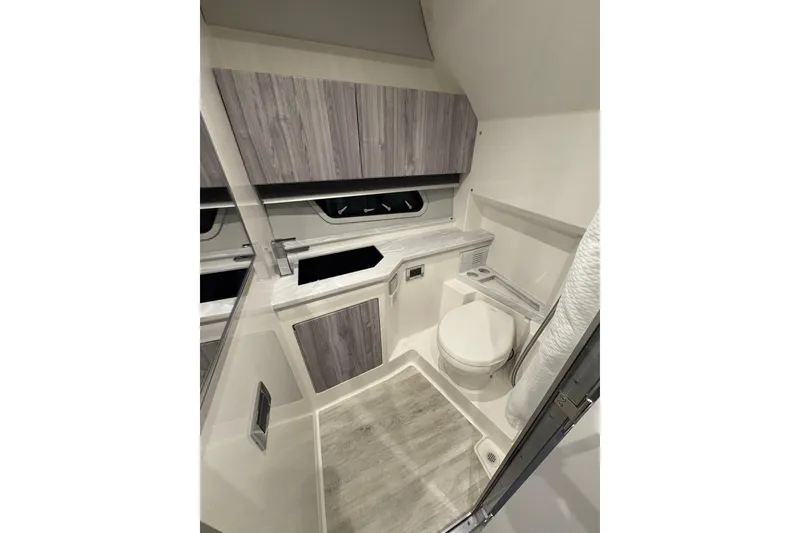 Slide: The Image of 2023 Formula 400 Super Sport Crossover bathroom with modern fixtures and wood accents. - 34