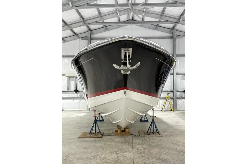 Slide: The Image of 2023 Formula 400 Super Sport Crossover boat in storage, front view. - 4