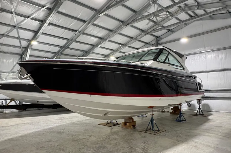 Slide: The Image of 2023 Formula 400 Super Sport Crossover boat in a spacious indoor storage facility. - 5