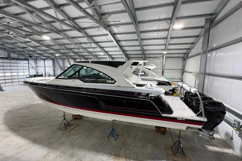 Slide: The Image of 2023 Formula 400 Super Sport Crossover boat in a spacious indoor storage facility. - 7