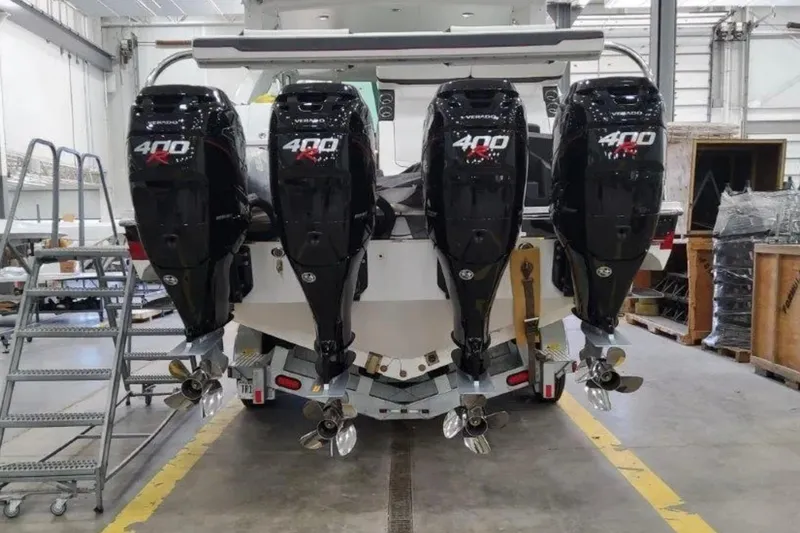 Slide: The Image of 2023 Formula 400 Super Sport Crossover with four powerful outboard engines in a workshop. - 8