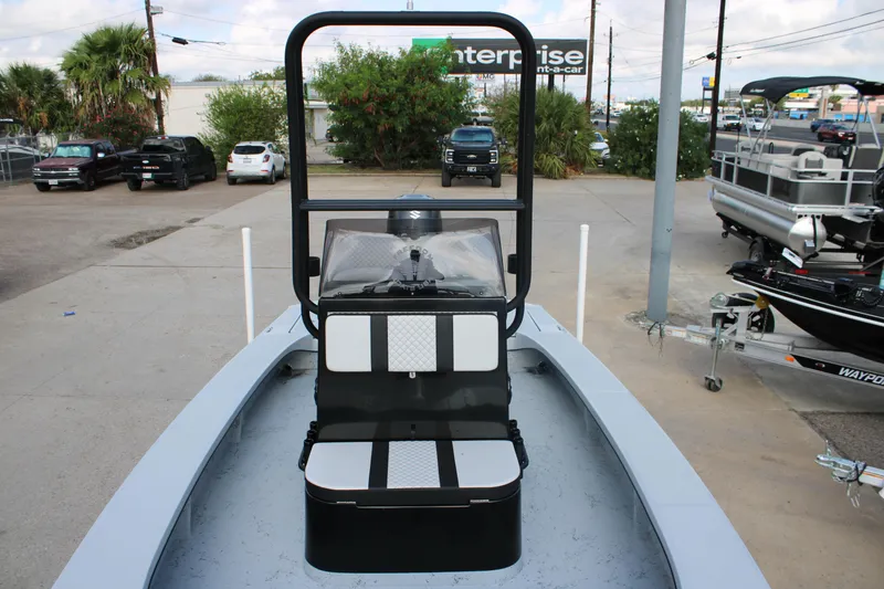 Slide: The Image of 2026 Freedom Boats 23' Warrior on trailer at dealership under clear blue sky. - 1