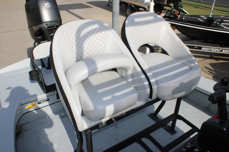 Slide: The Image of 2026 Freedom Boats 23' Warrior interior with speakers, parked at dealership. - 12