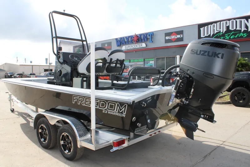 Slide: The Image of 2026 Freedom Boats 23' Warrior, spacious deck view, parked outdoors. - 4