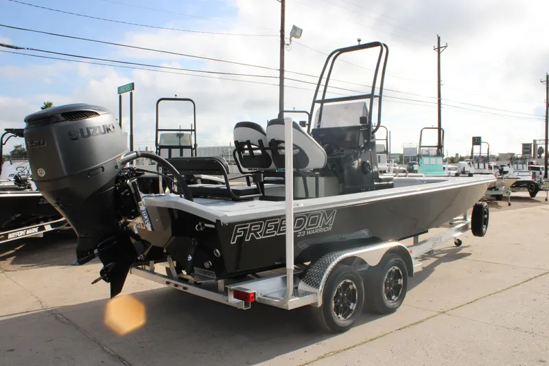 Slide: The Image of 2026 Freedom Boats 23' Warrior with open storage compartments on deck. - 6