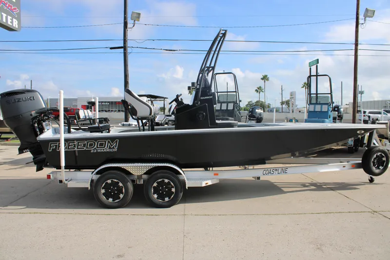 Slide: The Image of 2026 Freedom Boats 23' Warrior with seating, displayed outdoors under cloudy sky. - 7