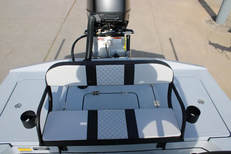 Slide: The Image of 2026 Freedom Boats 23' Warrior on trailer at dealership under cloudy sky. - 13