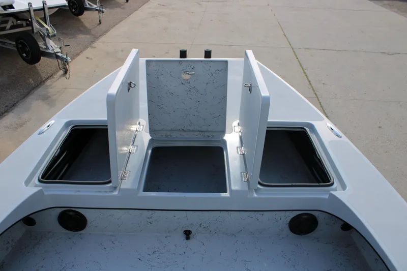 Slide: The Image of 2026 Freedom Boats 23' Warrior on trailer, parked outdoors under cloudy sky. - 14