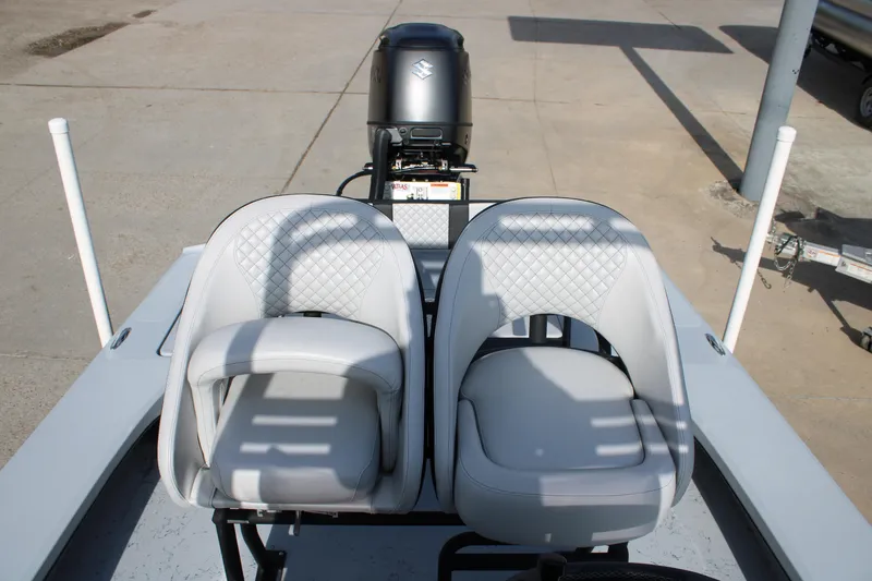 Slide: The Image of 2026 Freedom Boats 23' Warrior, rear view, showcasing seating and storage compartments. - 17