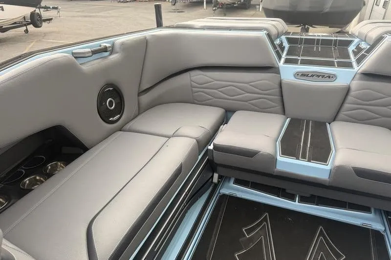 Slide: The Image of 2025 Supra SL 575 boat interior with gray seating and modern design. - 6