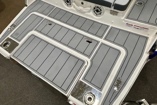 Slide: The Image of 2026 Chaparral 8 SSX boat deck with gray non-slip surface and integrated speakers. - 11