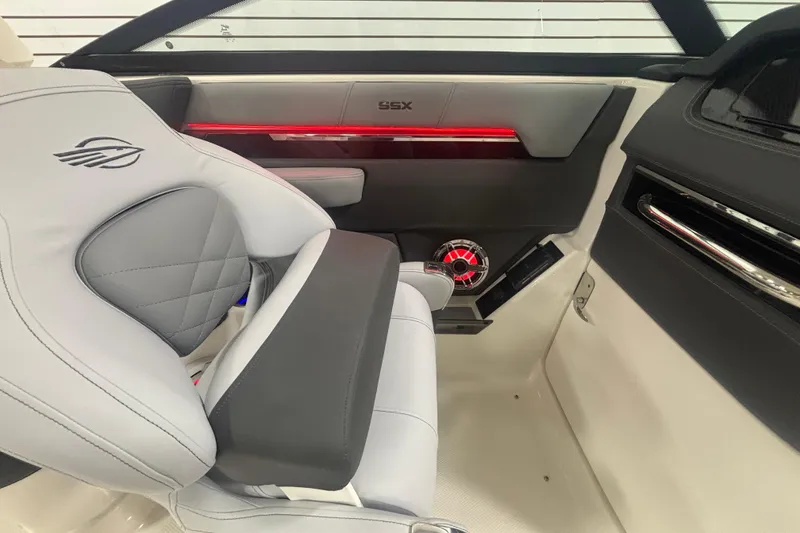 Slide: The Image of Interior of 2026 Chaparral 8 SSX boat with modern seating and red accent lighting. - 16