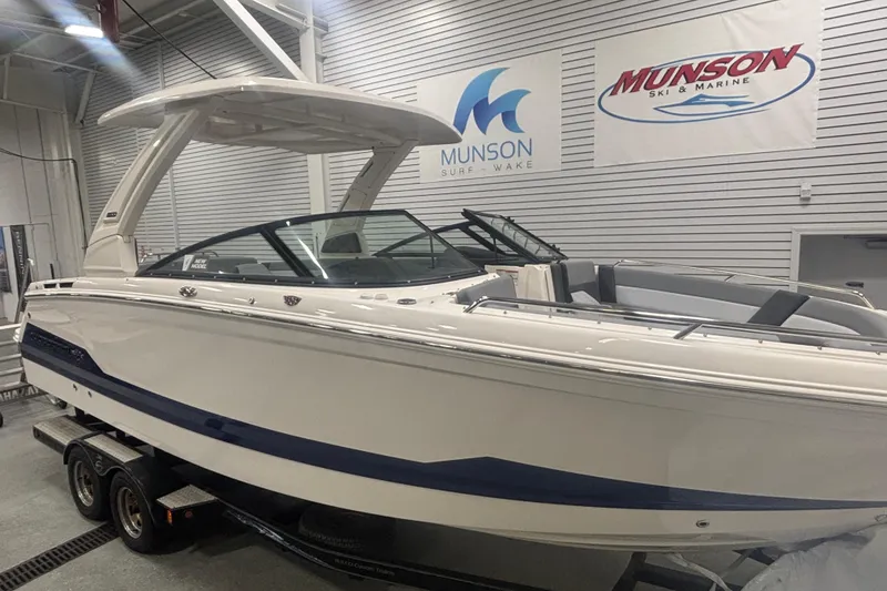 Slide: The Image of 2026 Chaparral 8 SSX boat displayed indoors at Munson Ski & Marine showroom. - 2