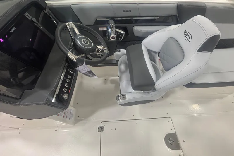 Slide: The Image of 2026 Chaparral 8 SSX boat interior with steering wheel and captain's seat. - 22