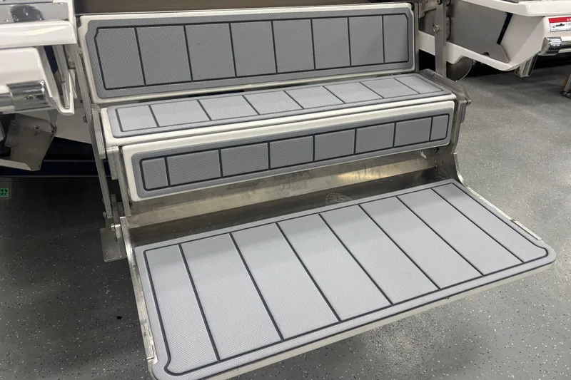 Slide: The Image of 2026 Chaparral 8 SSX boat steps with non-slip gray padding. - 35