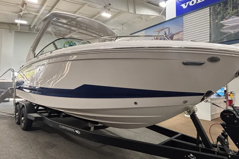 Slide: The Image of 2026 Chaparral 8 SSX boat on display in showroom, featuring sleek design and modern features. - 7
