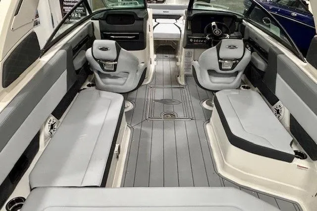 Slide: The Image of 2026 Chaparral 8 SSX boat interior with sleek gray seating and modern dashboard. - 8