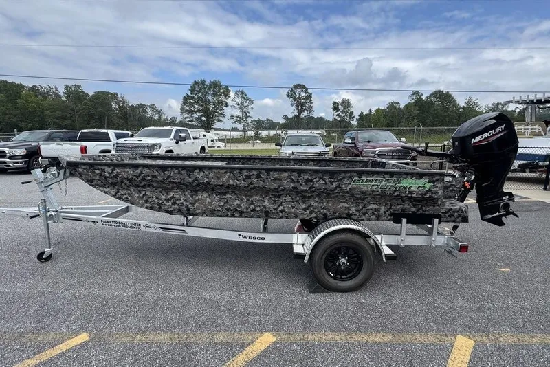 The Image of 2024 Havoc 1756 boat on trailer with camo design and Mercury outboard motor. - 0