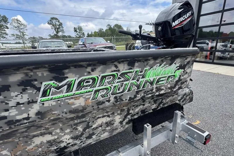 Slide: The Image of 2024 Havoc 1756 Marsh Runner boat with camo design and Mercury outboard motor. - 1