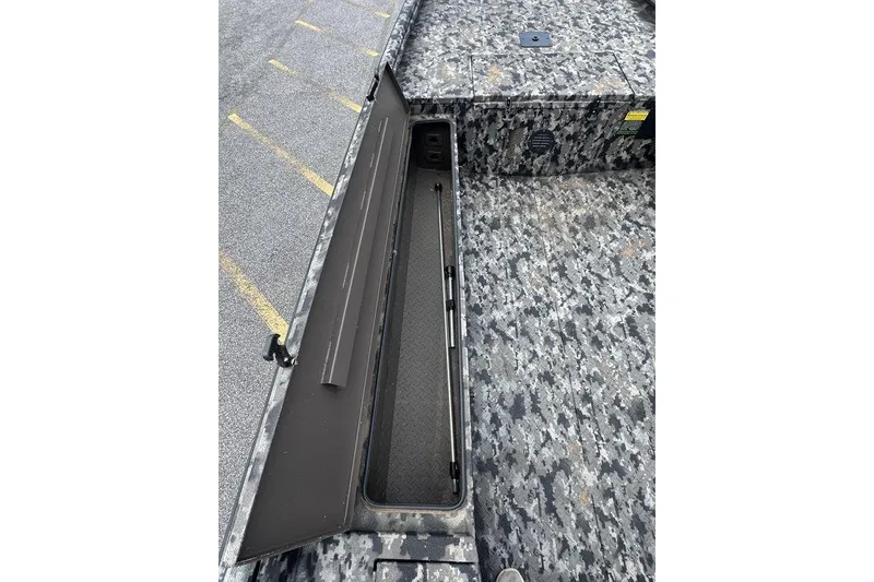 Slide: The Image of 2024 Havoc 1756 boat with open storage compartment, camo pattern deck. - 13