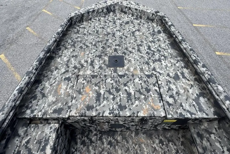 Slide: The Image of 2024 Havoc 1756 boat with digital camouflage pattern on deck, parked on asphalt. - 15