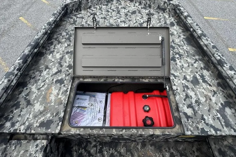 Slide: The Image of 2024 Havoc 1756 boat with camo design, open storage compartment revealing red fuel tank. - 16