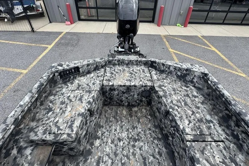 Slide: The Image of 2024 Havoc 1756 boat with camouflage pattern, parked outside a building. - 5