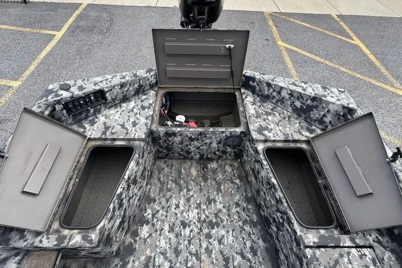Slide: The Image of 2024 Havoc 1756 boat with open storage compartments and digital camouflage design. - 7