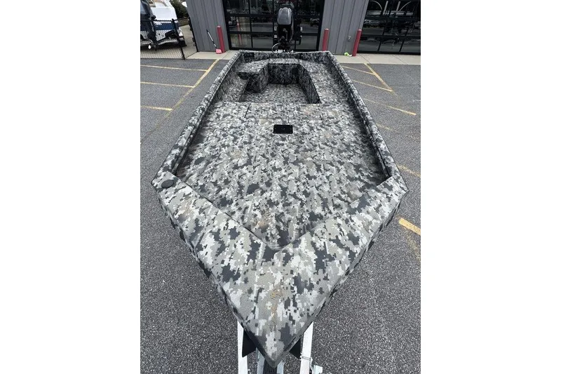 Slide: The Image of 2024 Havoc 1756 boat with digital camouflage design, parked outdoors. - 8