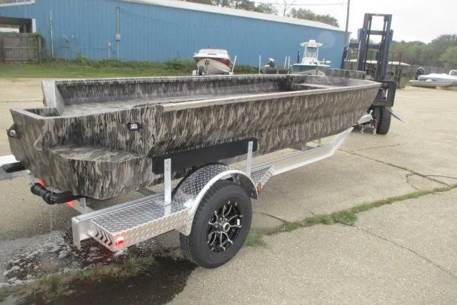 Slide: The Image of 2026 Reaper Boats 756-1687 with Yamaha engine, camo design, in showroom setting. - 1