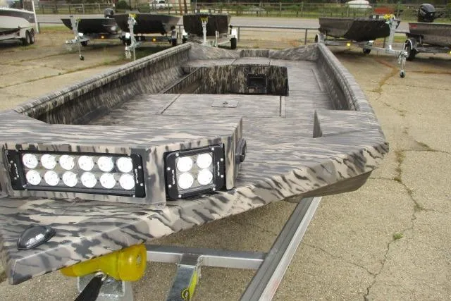 Slide: The Image of 2026 Reaper Boats 756-1687 model with camouflage design and LED lights on trailer. - 7