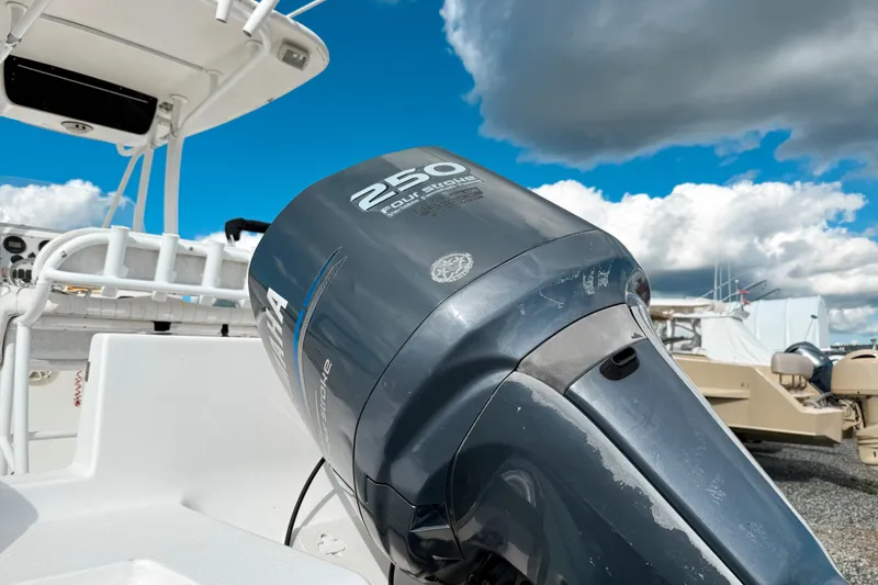 Slide: The Image of 2011 Tidewater 230 CC Adventure boat with Yamaha 250 four-stroke engine under cloudy sky. - 3