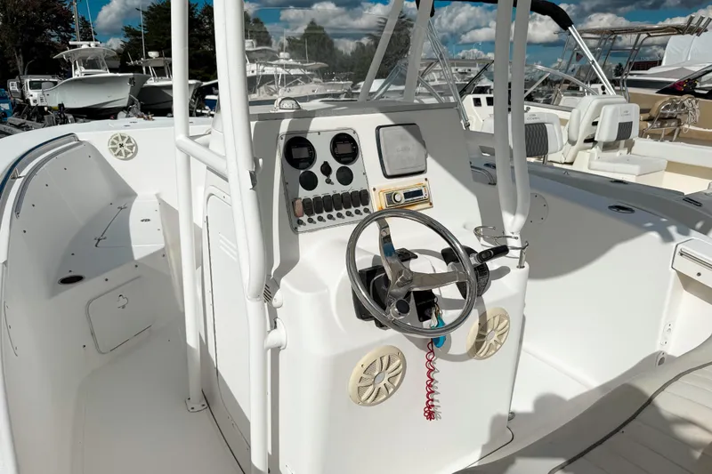 Slide: The Image of 2011 Tidewater 230 CC Adventure boat cockpit with steering wheel and control panel. - 6