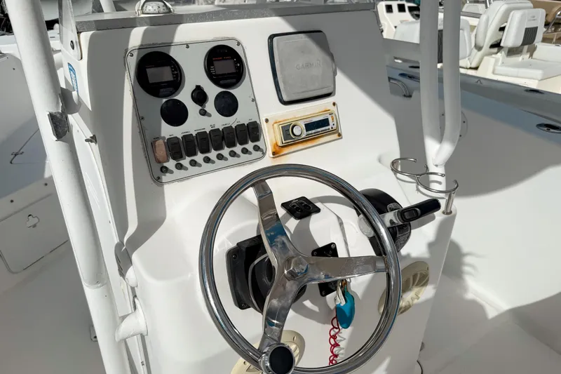Slide: The Image of 2011 Tidewater 230 CC Adventure boat console with steering wheel and controls. - 7