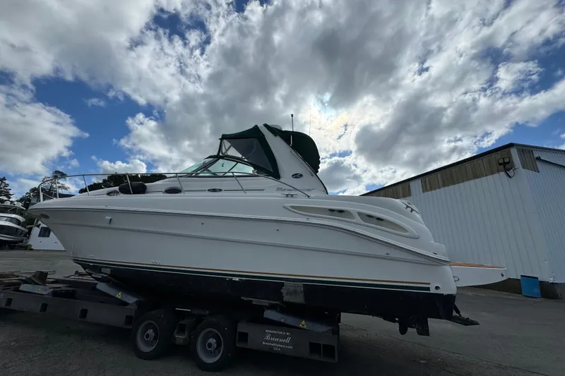 Slide: The Image of 2001 Sea Ray 340 Sundancer boat on trailer under cloudy sky. - 1
