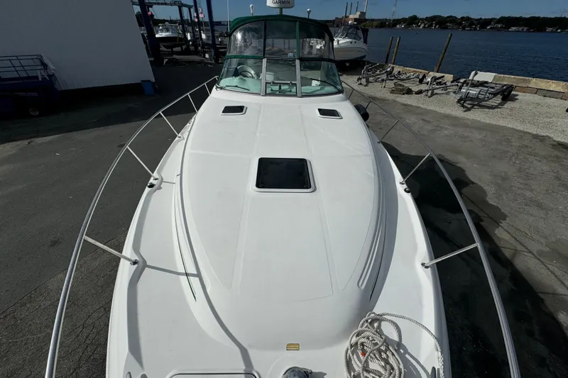 Slide: The Image of 2001 Sea Ray 340 Sundancer boat docked near a marina with clear skies. - 8