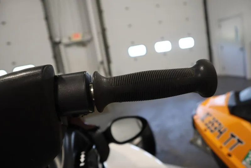 Slide: The Image of Close-up of 2015 Sea-Doo Spark for 3 handlebar grip in a garage setting. - 12