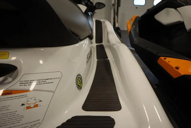 Slide: The Image of 2015 Sea-Doo Spark for 3 jet ski, close-up view of seating and warning label. - 16