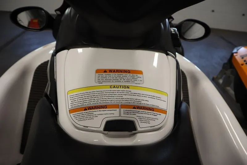 Slide: The Image of 2015 Sea-Doo Spark for 3 with visible warning and caution labels on the seat. - 20